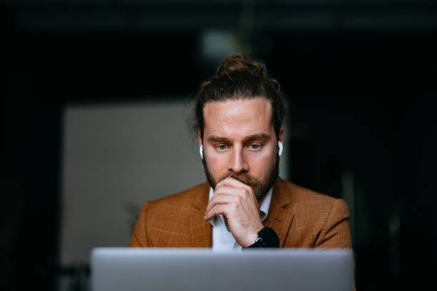 Serious Businessman Talking On A Video Call Using A Laptop Computer In The Office