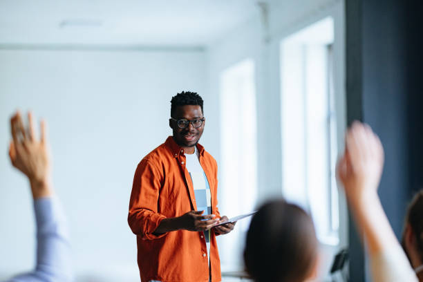 istock Smiling Business Man Talking To Audience During A Q And A Session 1444535694