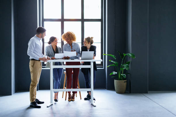 istock Smiling Businesspeople Working Together On A New Project 1444535972