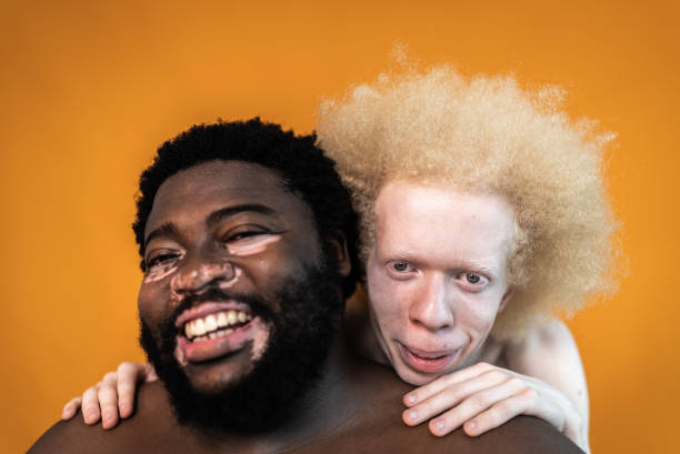 portrait of male friends on an orange background - shirtless men bizarre male imagens e fotografias de stock