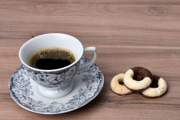 istock cup with coffee and chocolate milk donut snack breakfast isolated on table with copy space 1444537611