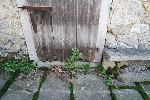 Barred basement window of an old building close up