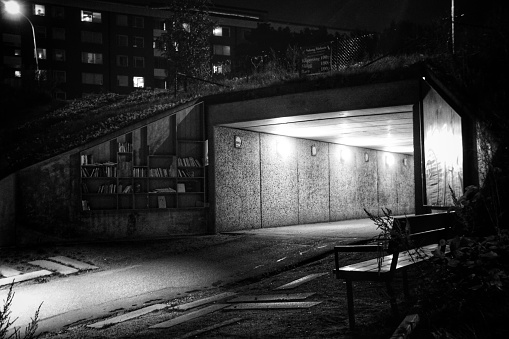 Empty illuminated tunnel in city at night