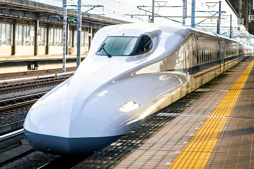 Kyoto, Japan - October 16, 2022: Express white high speed bullet train at track boarding in Japan