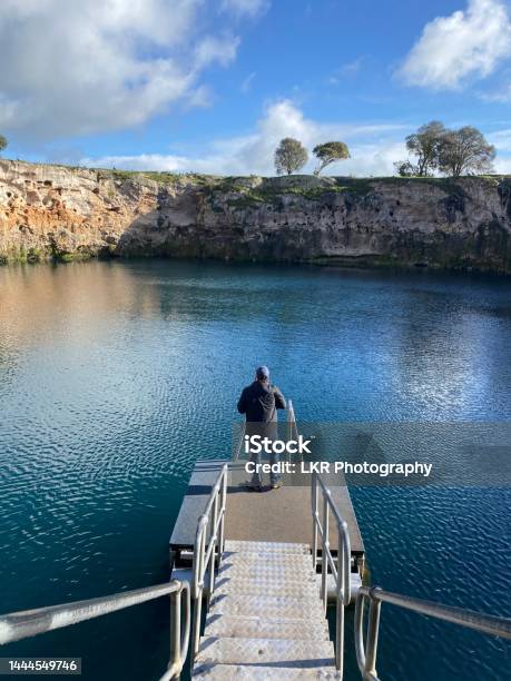 A Man Standing On A Floating Pontoon On Little Blue Lake At Mount Gambier In South Australia Stock Photo - Download Image Now