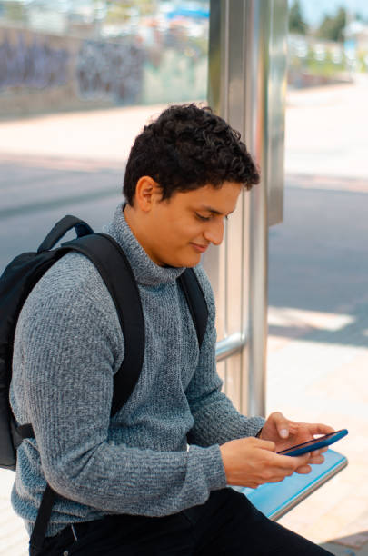 istock Man with smartphone at bus stop 1444558495