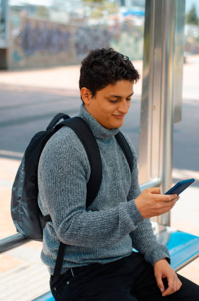 istock Man with smartphone at bus stop 1444558508