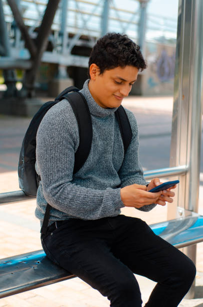 istock Man with smartphone at bus stop 1444558515