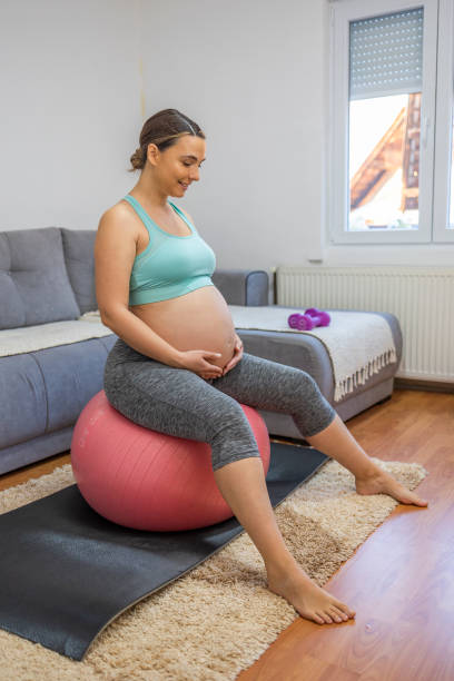 istock Pregnant woman training at home 1444558559