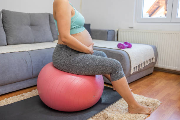 istock Pregnant woman training at home 1444558719