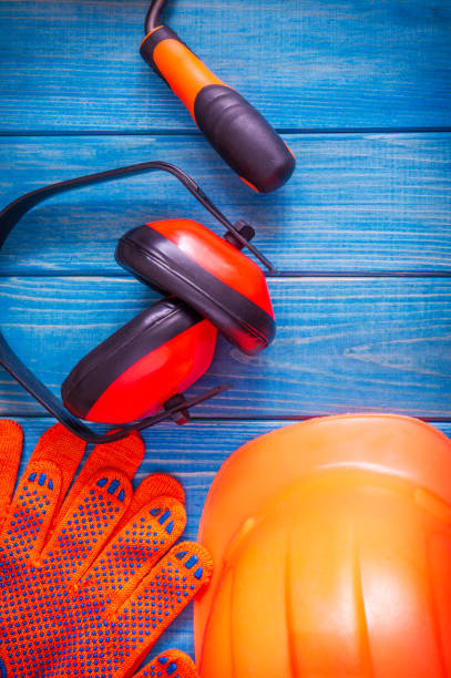 istock Orange hard hat and tool on wooden vintage blue boards 1444558902