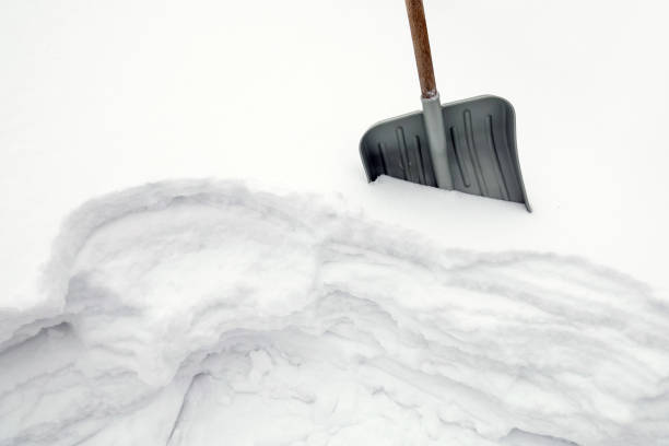 istock Snow shovel is stuck into snowdrift, snowy winter 1444561727