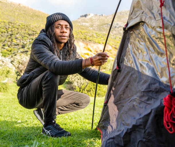 istock Young man finishing setting up a tent at a campsite 1444566525