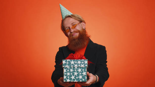 istock Smiling man presenting birthday gift box stretches out hands, offer wrapped present career bonus 1444569798