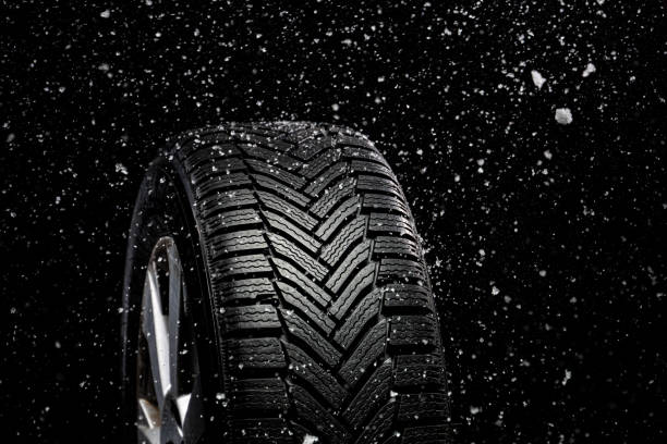 istock New winter car tire while snowing 1444571208
