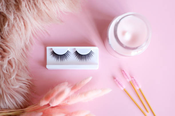 istock Tools for eyelash extension on trendy pastel pink background. False eyelashes, tweezers and brushes. Beauty shop. Makeup cosmetics. Top view, flat lay 1444572869