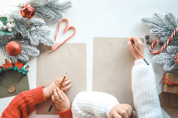 istock Children write a letter to Santa on craft sheets, top view, space for your text 1444572882