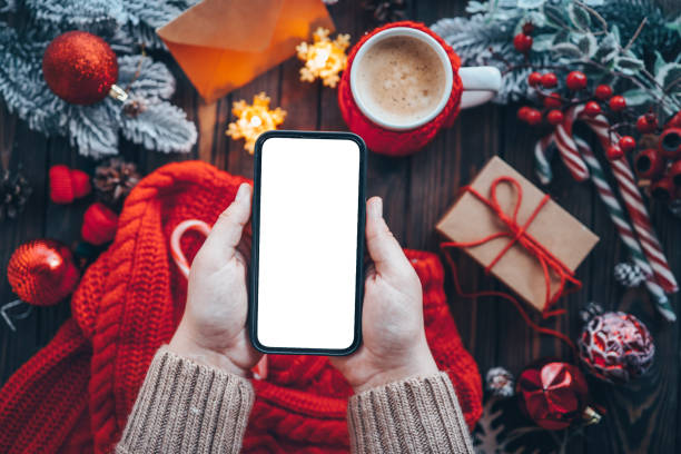 istock Phone in hands with isolated place for text in Christmas atmosphere 1444572908