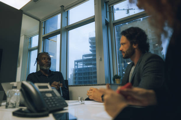 istock Coworkers talking at the conference table 1444574352