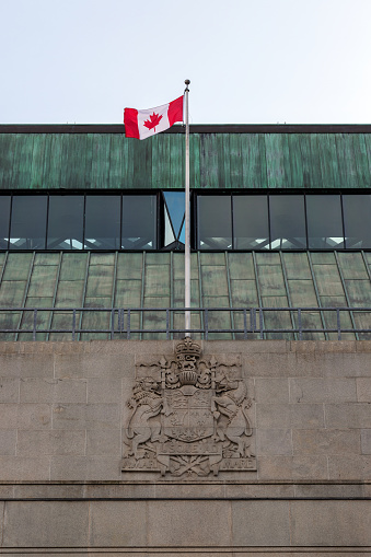 Ottawa, Canada - November 10, 2022: Bank of Canada building with Canadian flag.