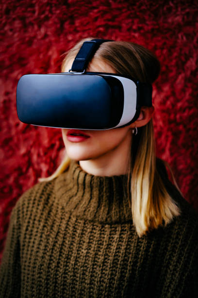 istock Young woman wearing VR headset 1444585487