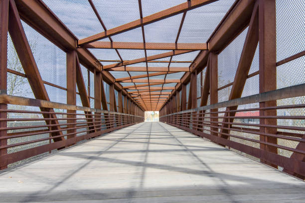 istock Metal covered girder pedestrian bridge with diminishing perspective 1444591196