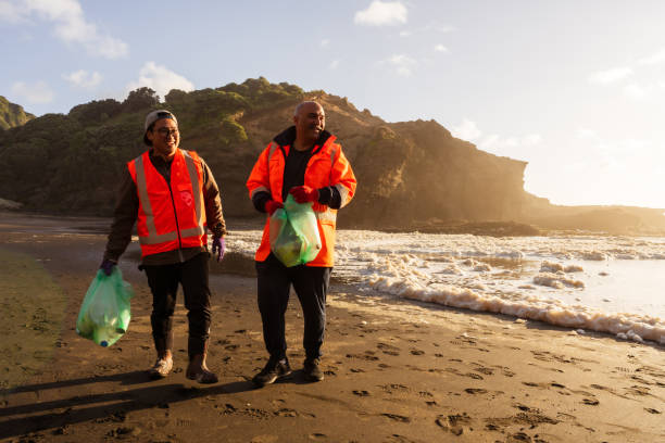 istock Male volunteers satisfied while picking up trash. 1444594983