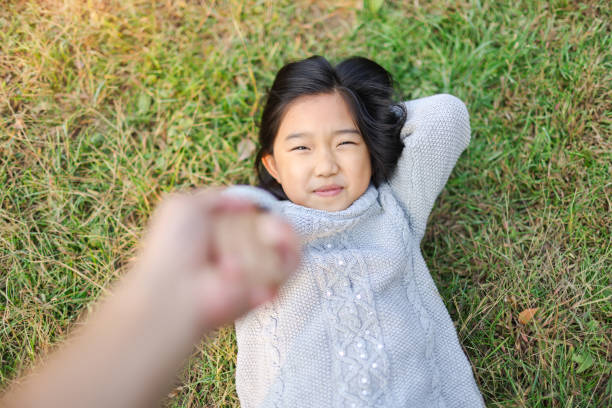istock Mom pulled up her daughter off the grass 1444598286