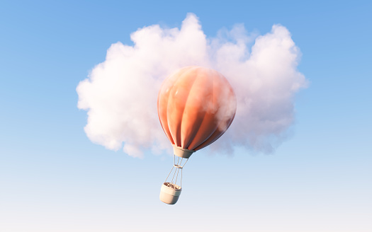 Colorful hot air balloon flying against blue cloudy sky. Lots of copy space.