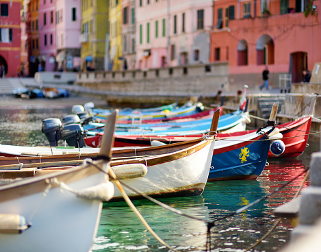 Colourful fishing boats in small marina of Vernazza, one of the five centuries-old villages of Cinque Terre, located on rugged northwest coast of Italian Riviera, Liguria, Italy.