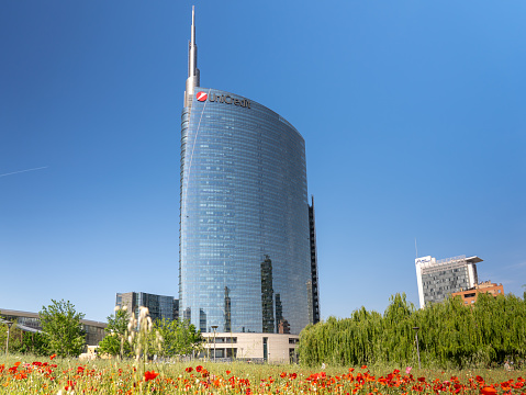 Milano, Italy. The iconic Unicredit tower at Gae Aulenti square. Skyscraper which is part of a group of residential and business buildings. Architectural modern buildings