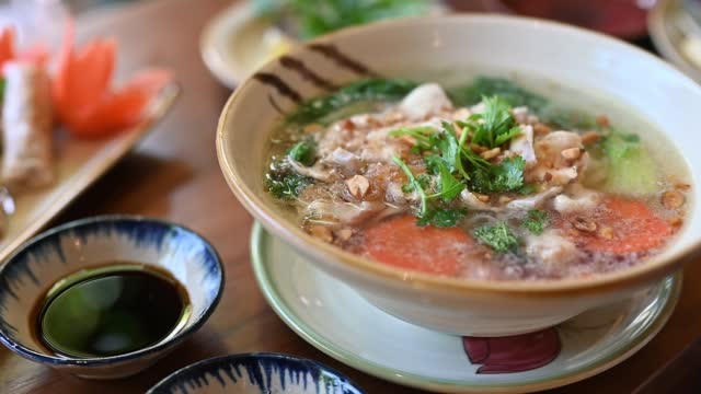 Traditional Vietnamese pho soup on a wooden background