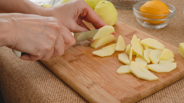 istock Apple slices close up on a wooden board on rustic background. Apple cake with biscuit base recipe 1444623239
