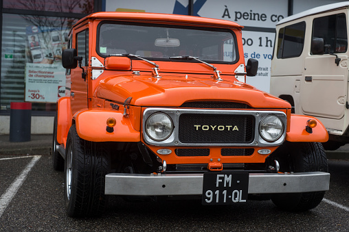 Mulhouse - France - 13 November 2022 - front view of orange color Toyota landcruiser customised parked in the street