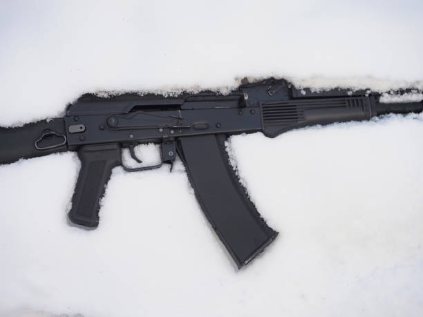 istock Black metal gun machine in snow 1444623563