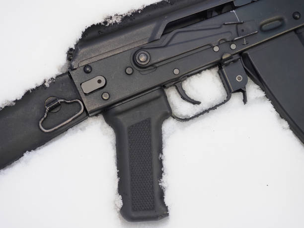 istock Black metal gun machine in snow 1444623564