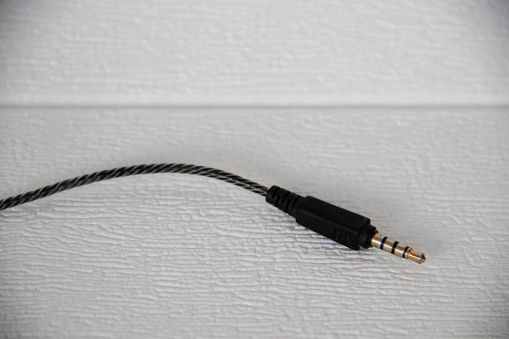close up of plugged-in lan cable in a home router/switch, isolated on white