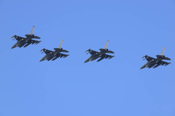 United States Air Force Lockheed Martin F-16C Fighting Falcon multirole fighter aircraft flying in formation. Aomori Prefecture, Japan - September 07, 2014: United States Air Force Lockheed Martin F-16C Fighting Falcon multirole fighter aircraft flying in formation. misawa japan stock pictures, royalty-free photos & images