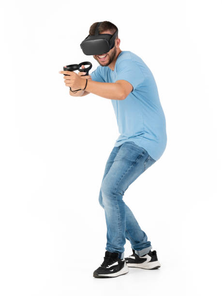 istock Young man playing with a VR glasses on a white background 1444650457