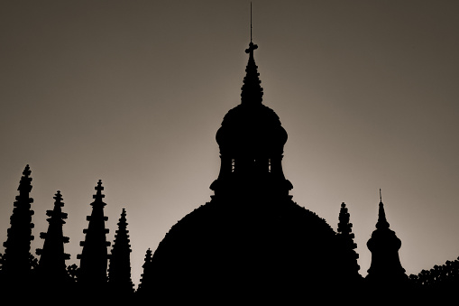Silhouette of the cathedral of Segovia at sunset with pigeons on the roofs