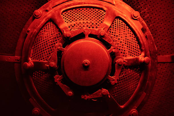 Round machine or bunker door with red and dramatic lighting.
