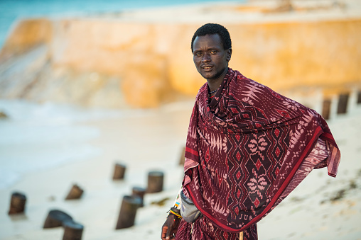 Zanzibar, Tanzania - January 02,2022: The Maasai warriors dressed in traditional clothes on sand beach of Zanzibar island.