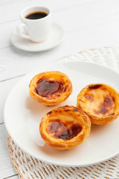 istock Traditional Portuguese egg tart dessert Pasteis Pastel de nata or Pasteis de Belem with coffee over white background 1444668323