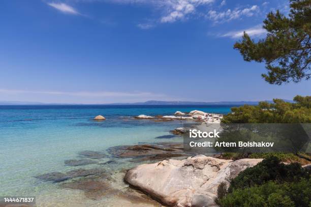 Kavourotrypes Or Portokali Beach Is Phenomenal Beach On Sithonia With Many Round Or Flat Rocks As White As Little Clouds In Blue Sky Pines Come Right Up To Water Sithonia Halkidiki Greece Stock Photo - Download Image Now