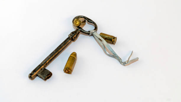 istock Antique key with three bullets. Book cover 1444673489