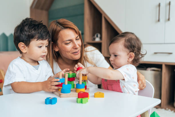 istock Mother playing with toddlers 1444676300