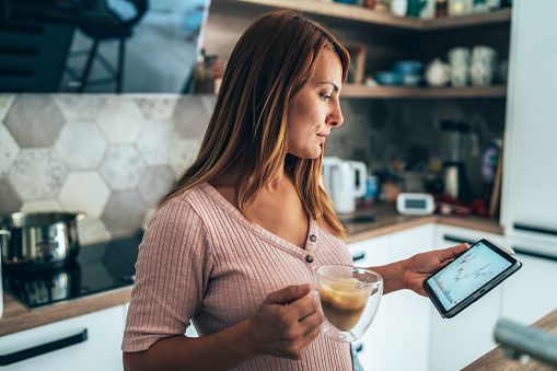 Business woman making money as crypto trader investor broker at home. Woman at home office trading Online Using digital Tablet