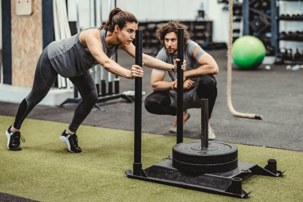 istock gym Sled with a Personal Trainer 1444679184