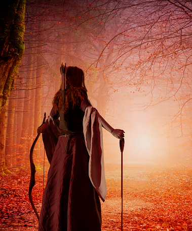A red-haired woman archer of the Middle Ages with a bow in an autumn forest. Fantasy world. 3d rendering