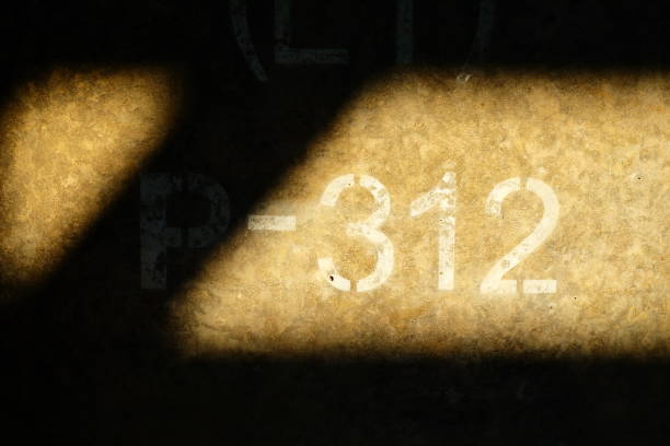 312 inscription on Concrete Wall with Sunlight Beam.